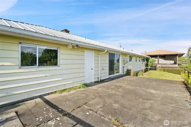 Large back patio off garage & slider. Stairs to lower level grass, vintage chicken coup and views!