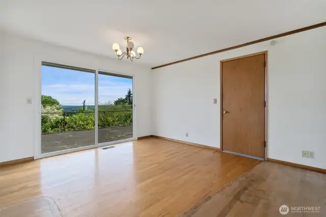Dining area with door to garage and slider to back patio and back yard.