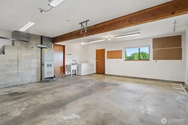 Generous 2 Car Garage with laundry area, outdoor patio access and views!