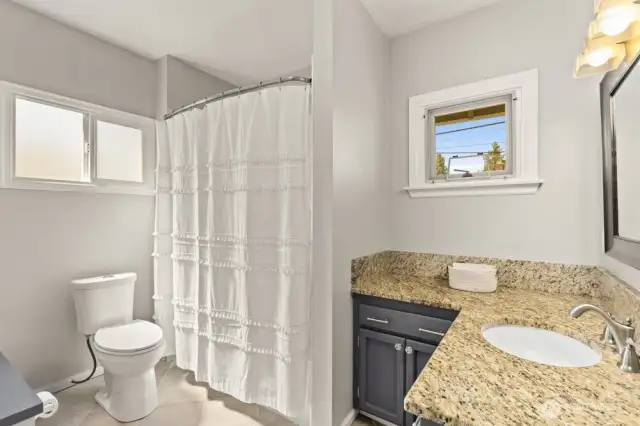 The full bath is set just behind the kitchen—nicely out of the way and perfect for keeping things private.
