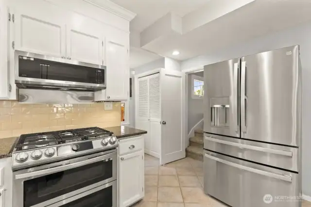 The full bath is to the right of fridge down a hallway. Now it’s time to head upstairs and check out the primary suite—a private retreat all your own.