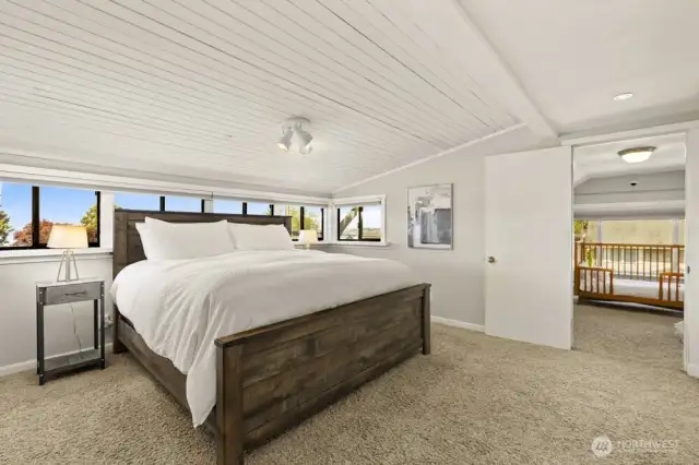 The primary suite, where comfort, space, and a little peek at the bay are waiting for you.