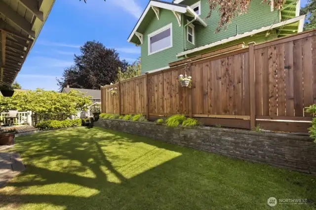 The yard is framed by a canopy of mature trees, adding both privacy and that lush, Pacific Northwest charm buyers love.