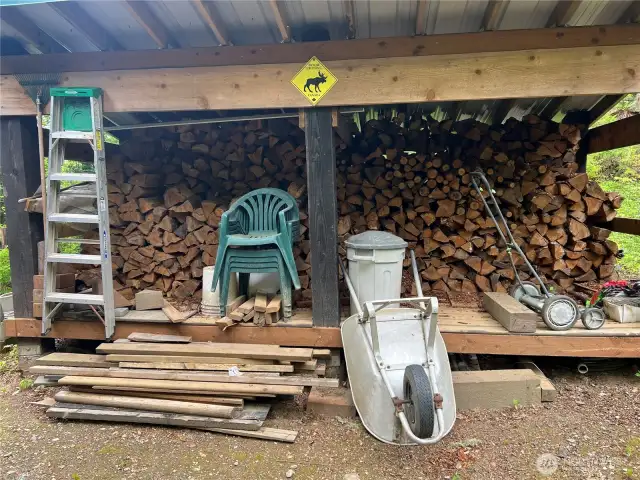 Excellent wood shed to keep your firepit stocked and burning.