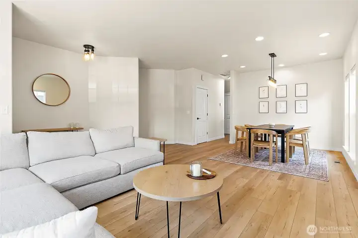 Open dining and living room combination with a perfect view of the cozy fireplace—an ideal setting for gatherings.