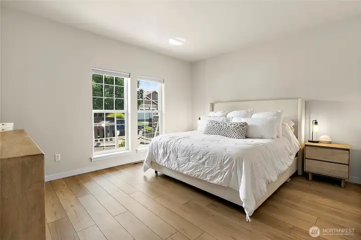 The spacious primary bedroom located on the main floor, offers a peaceful retreat, complete with a large walk-in closet and a fully updated en suite bath