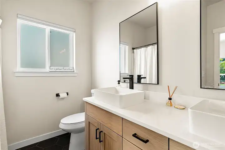 Beautifully updated with new tile, cabinetry, lighting, and dual sinks, the primary bath offers a true spa-like retreat.