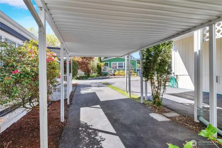 Carport has rhodie & hydrangeas nearby