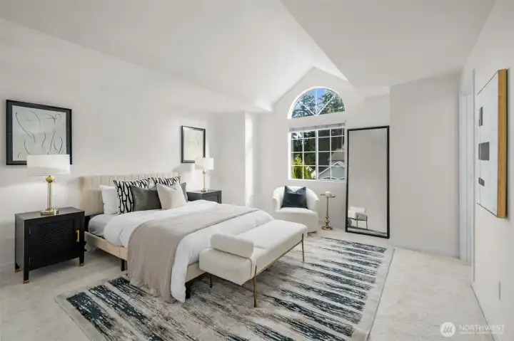 A joyful retreat, the primary suite boasts vaulted ceilings, fresh finishes, new carpet, a walk-in closet, and an attached spa-like bathroom.