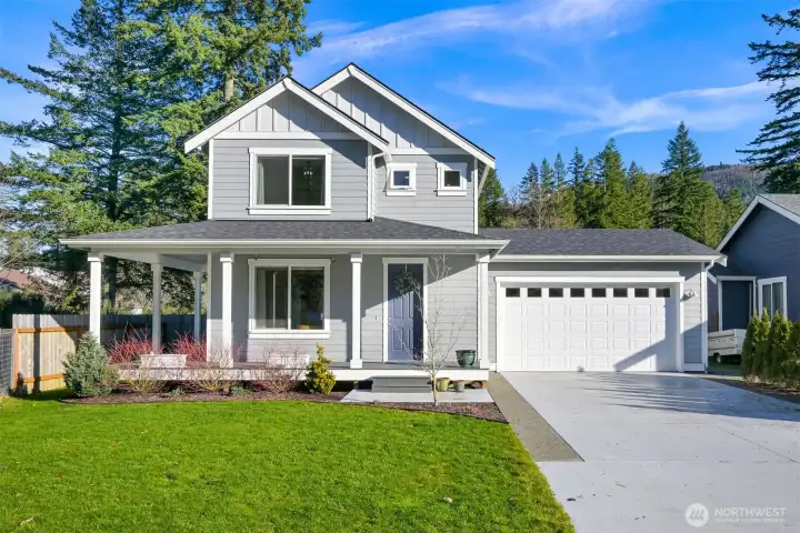 The large driveway, sprawling front yard and front deck on this home can't be beat.