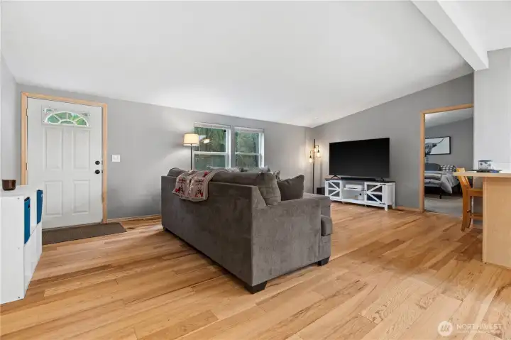 Enter through the main entrance into the open concept living space. The primary suite (through the door on the right) is situated on its own "wing on the house" for added privacy.