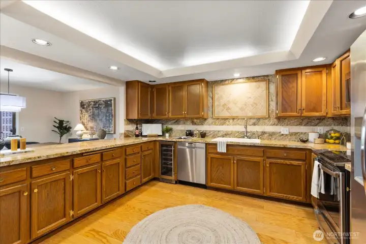 Kitchen is oversized with slab granite counters, tile backsp0lash and s/s appliance pkg.