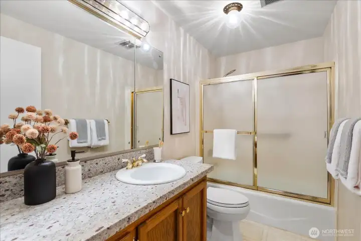enjoys a full bath just adjacent.