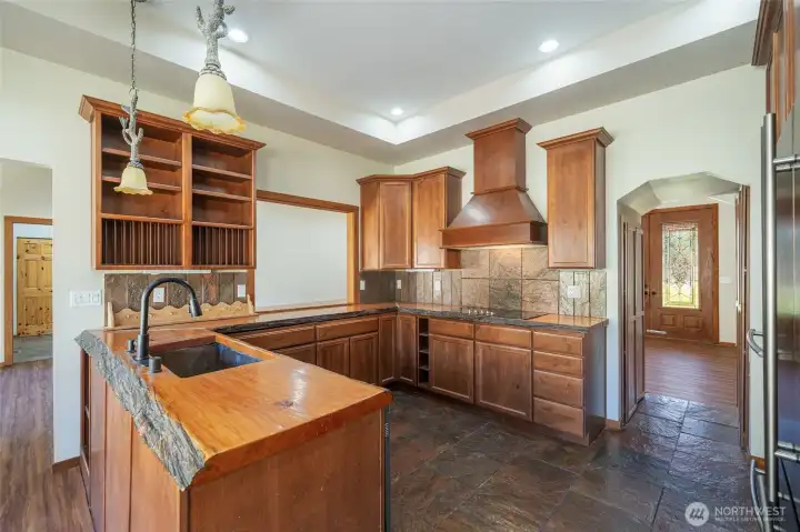 Kitchen with live-edge slab countertops Kitchen with live-edge slab countertops