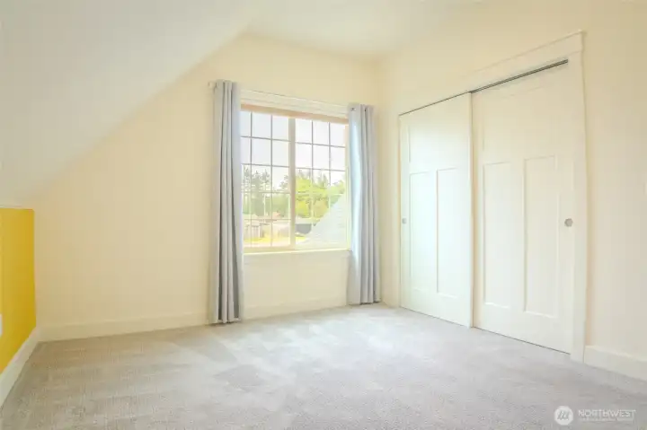 upstairs bedroom looks over the cozy back yard