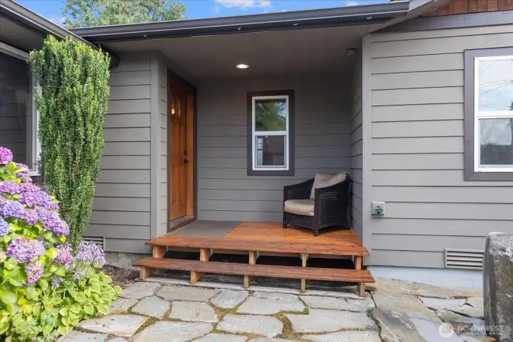 Charming front porch entry featuring a flagstone walkway and natural stone water feature. Charming front porch entry featuring a flagstone walkway and natural stone water feature.