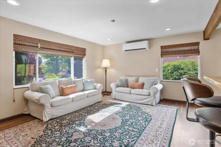 Cozy living area with large windows that flood the space with natural light in the afternoon. Cozy living area with large windows that flood the space with natural light in the afternoon.