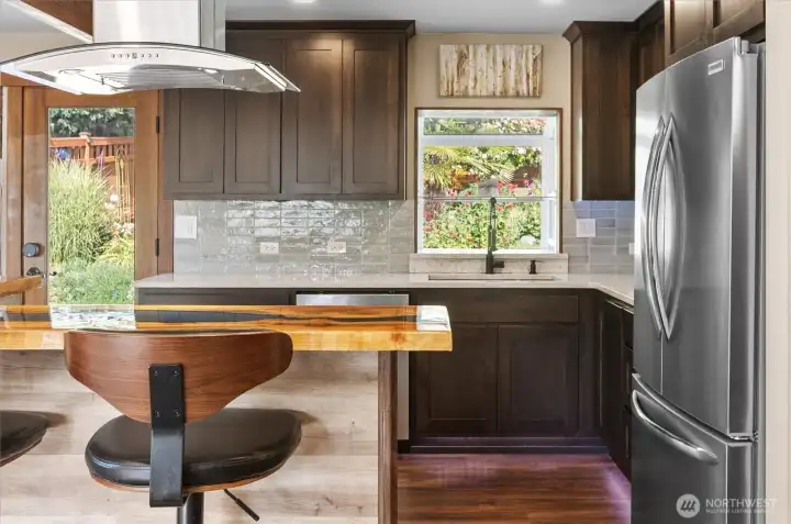 Bright, inviting kitchen with a charming garden window and serene views of the private backyard. Bright, inviting kitchen with a charming garden window and serene views of the private backyard.