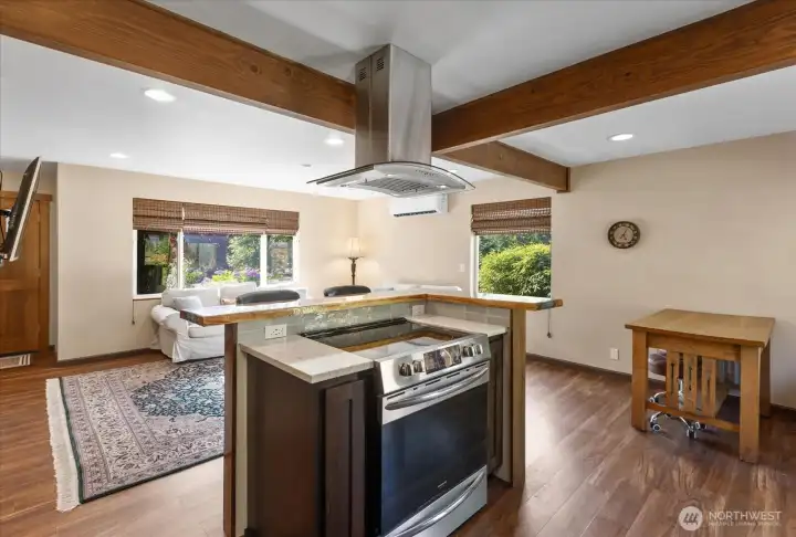 Open-concept kitchen looking to living area from stove island. Open-concept kitchen looking to living area from stove island.
