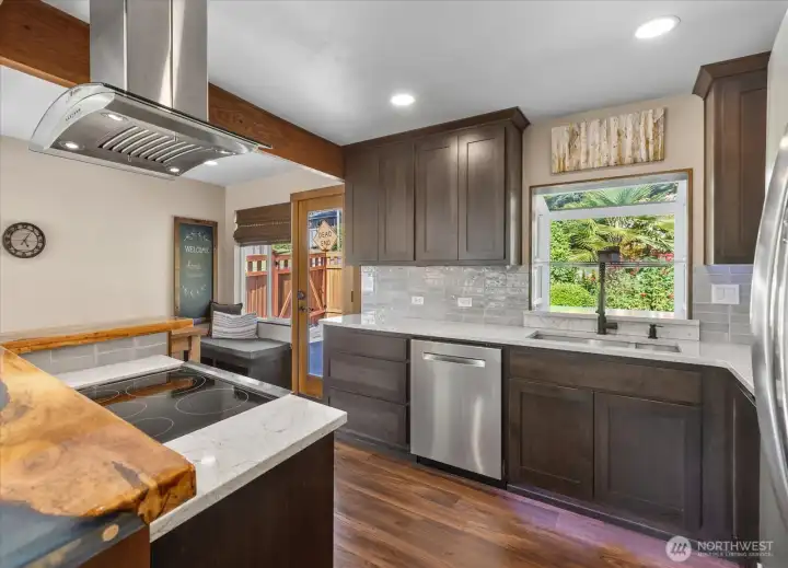 Kitchen view featuring an open layout towards the dining area with a glass door providing access to the backyard. Kitchen view featuring an open layout towards the dining area with a glass door providing access to the backyard.