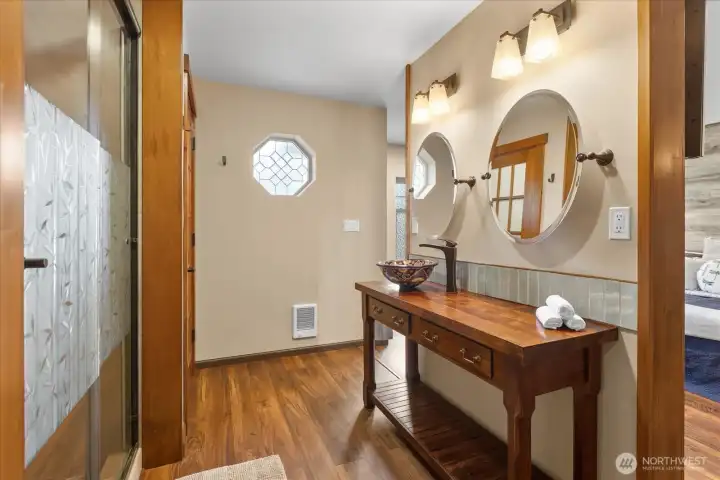 Beautifully designed primary ensuite featuring a custom vanity and sink. Beautifully designed primary ensuite featuring a custom vanity and sink.