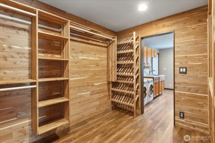Custom-designed, cedar-lined walk-in closet with convenient access to the laundry room and primary bedroom. Custom-designed, cedar-lined walk-in closet with convenient access to the laundry room and primary bedroom.
