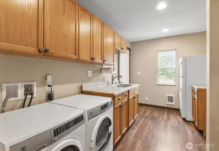 Laundry room with direct garage access and additional refrigerator. Laundry room with direct garage access and additional refrigerator.