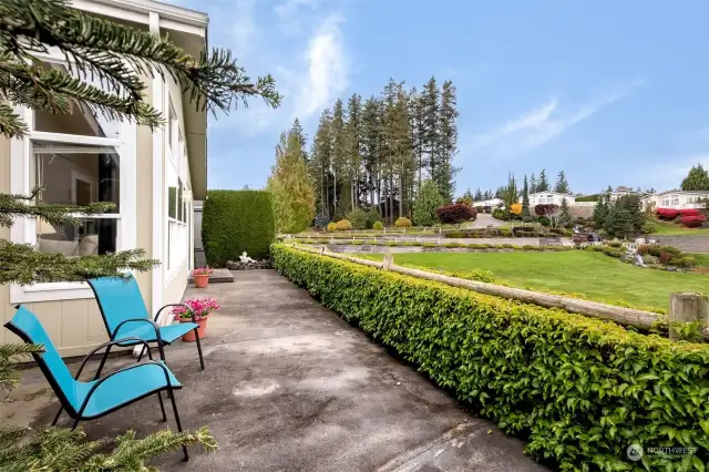 Back patio overlooks the amazing garden area with flowers and waterfalls.