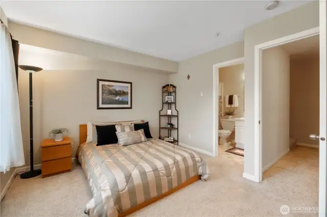 Retreat to your peaceful primary bedroom, complete with direct access to your own private bathroom. This comfortable space easily fits a queen-sized bed and features soft carpeting, natural light, and a cozy corner for reading or a home office. The attached en-suite makes mornings more efficient and evenings more restful.