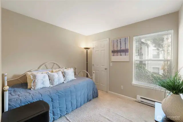 This bright and cozy secondary bedroom offers a flexible space perfect for guests, a home office, or a creative studio. Natural light pours through the large window, and a generous closet provides extra storage. Neutral tones and soft carpet make it easy to personalize.