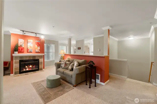 Step into a warm and inviting entryway that sets the tone for the rest of the home. The open-concept layout flows effortlessly into the living area, where large windows bring in an abundance of natural light. Crown molding and soft neutral tones create an elevated, welcoming ambiance from the moment you walk in.