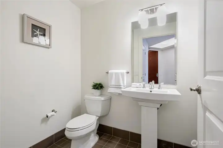 Sophisticated half bath designed for guests.