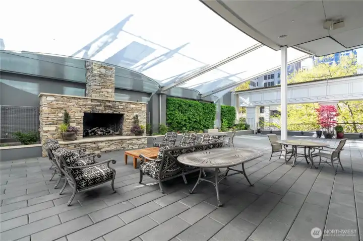 Cozy outdoor terrace featuring comfortable seating and dual gas grills, ideal for entertaining and relaxation.