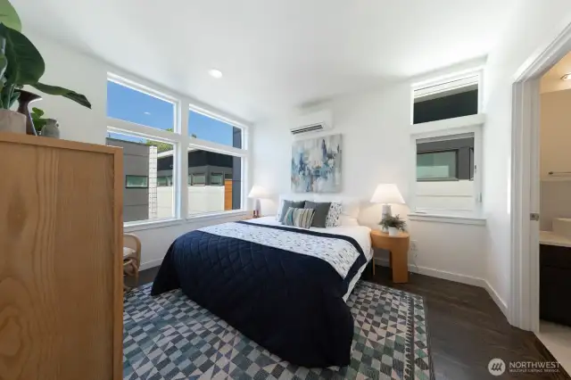 Primary suite on the upper level with abundant windows.
