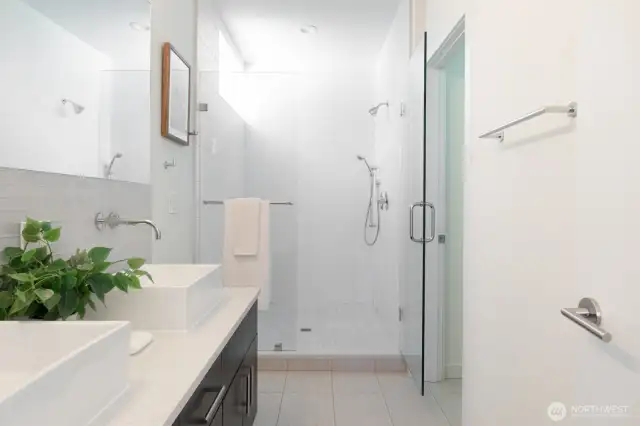 A fresh, spa-like bathroom with dual sinks and a walk-in shower.