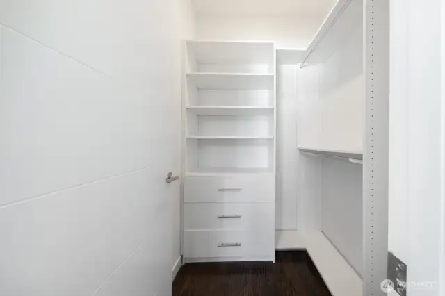 Walk-in closet with custom built-ins.