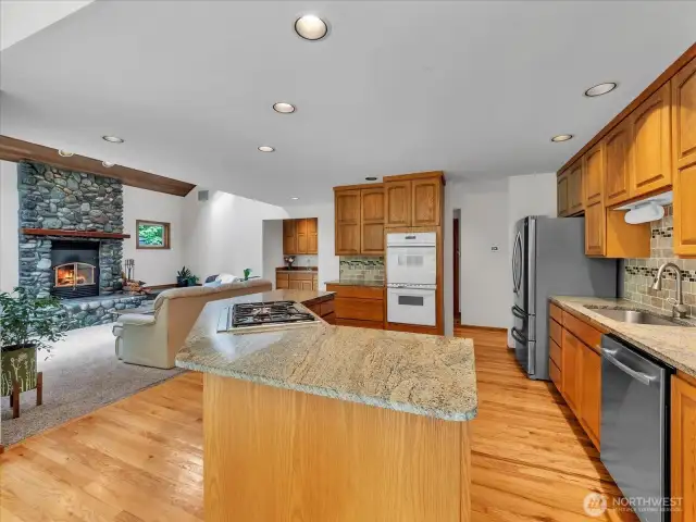 Gorgeous kitchen is off the family room. Plenty of cabinets, a wet bar in the family room and a walk-in pantry in the hallway.