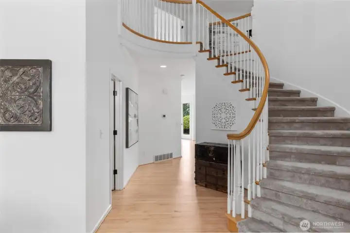 Grand staircase & freshly refinished hardwoods.