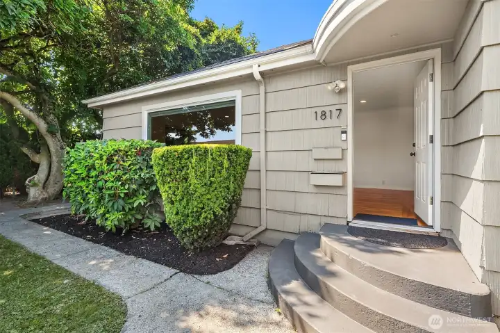 Paved walkway leading to entry of home.