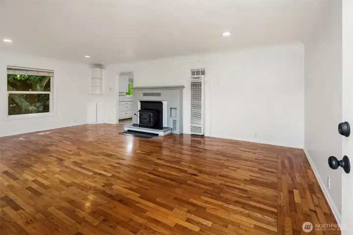 Front door opens to bright living space with original hard wood floors.