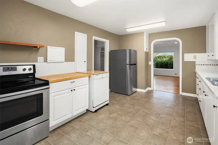 Spacious kitchen flowing seamlessly into living space.