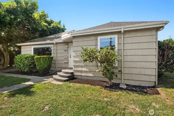 Spacious front yard with steps granting access to the front door.