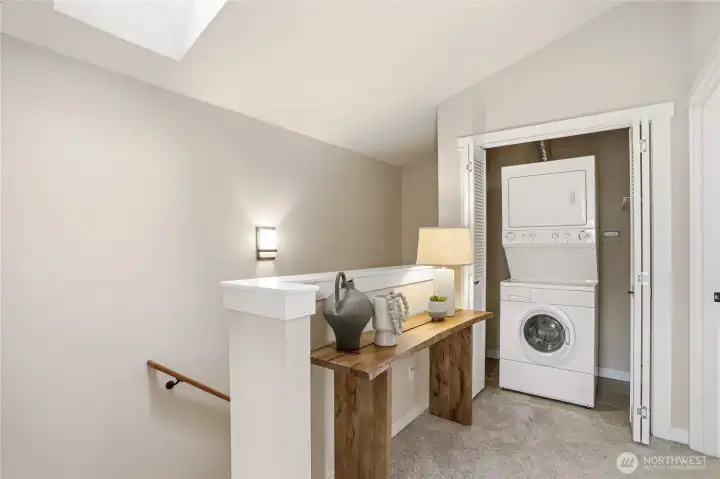 Stacked washer and dryer tucked neatly behind folding doors, right where you need them (adjacent the two upper level en-suites).