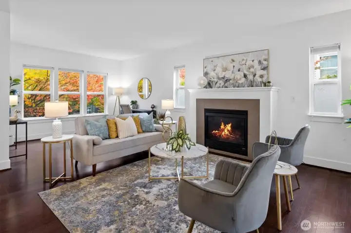 Cozy living room centered around a gas fireplace with tile surround and classic mantel.