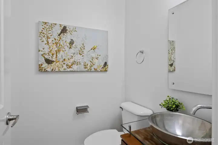 Convenient main-level powder bath with modern vessel sink and sleek fixtures.