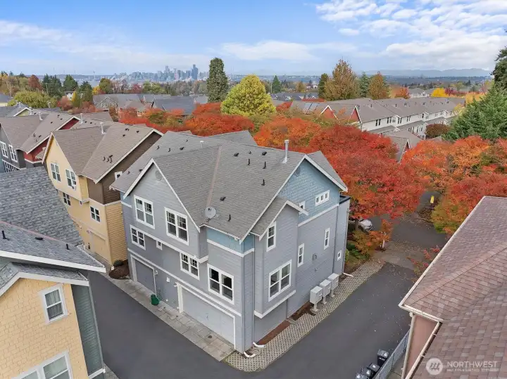 Back view of home showcasing modern siding and large windows.