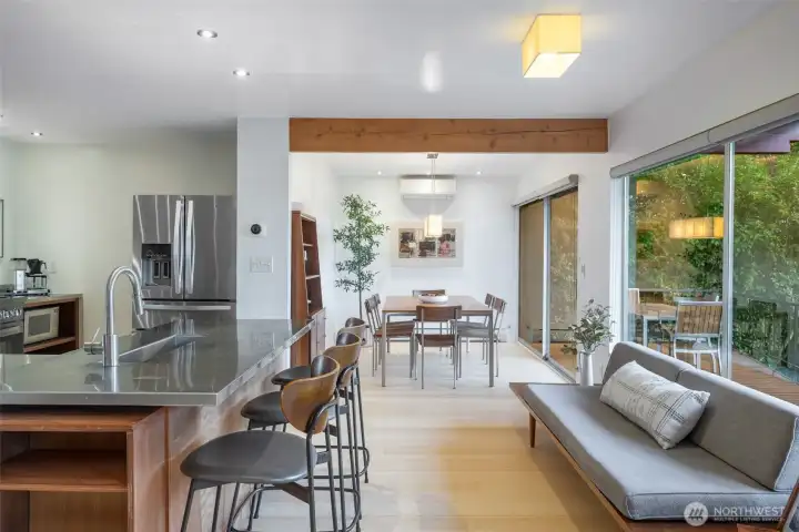 Kitchen is open to the living area and the dining area with expansive windows showcasing Lake Washington views.