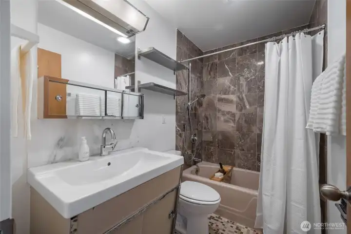 Updated primary bathroom with classic finishes.