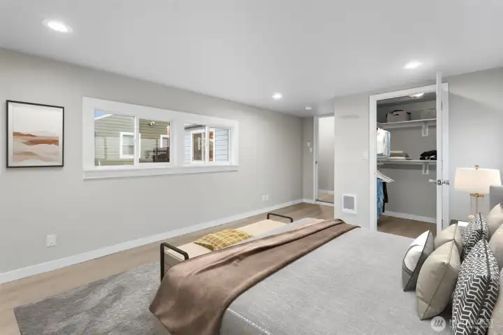 Virtually staged photo of  Primary bedroom. & walk-in closet.