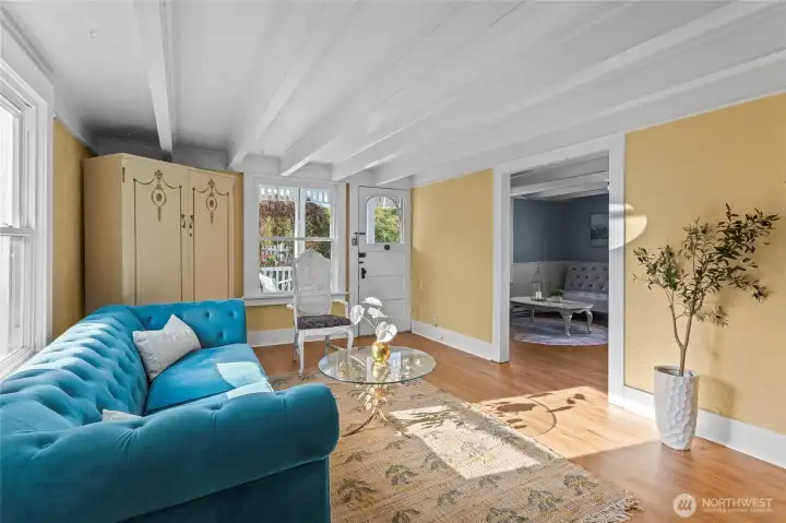 Beamed ceilings extend throughout the main floor with its front sitting rooms. Find a convenient 1/2 bath in the back corner.